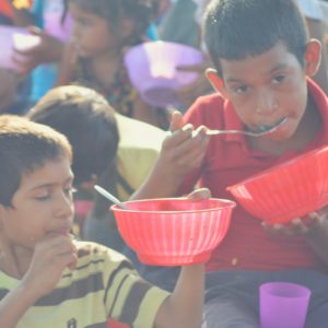 Wayuu childen eating meals distributed by Bread of Hope at the market.