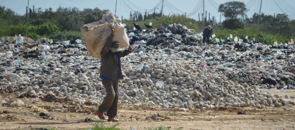 Wayuu men collecting trash for sale in landfill