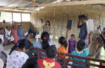 Wayuu people with their pastor in church.