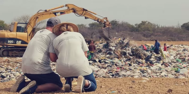Bread of Hope team praying on a landfill near Maicao, Colombia.
